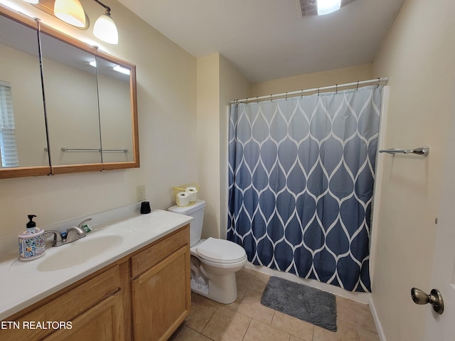 bathroom featuring vanity, toilet, a shower with curtain, and tile patterned floors