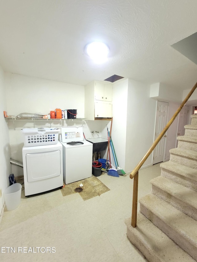 laundry area with cabinet space, independent washer and dryer, and baseboards