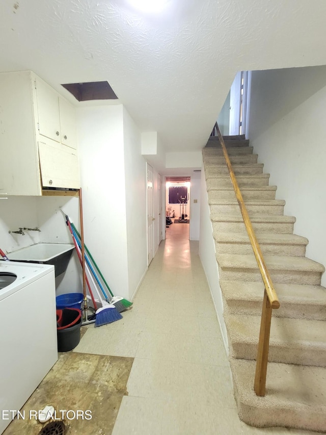 staircase featuring washer / dryer and tile patterned floors