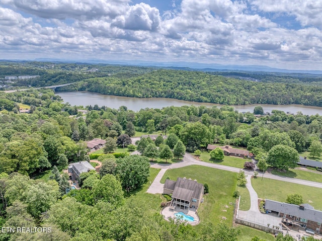 bird's eye view of a heavily wooded area and a large body of water
