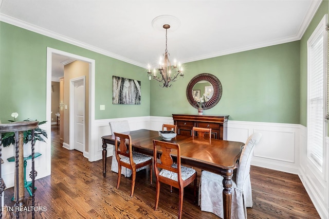 dining room featuring a chandelier, wainscoting, ornamental molding, and dark wood-type flooring