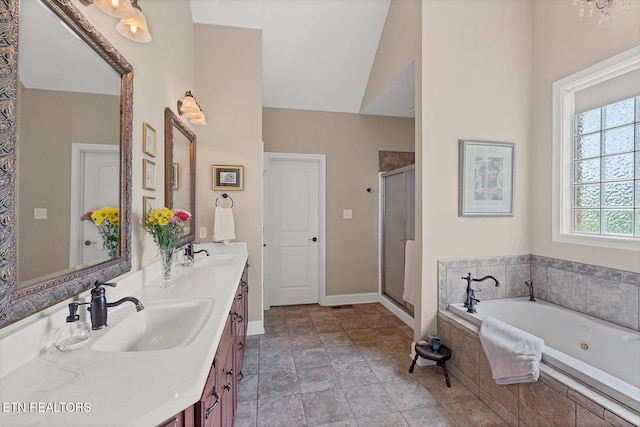 full bath with a whirlpool tub, a shower stall, double vanity, and baseboards