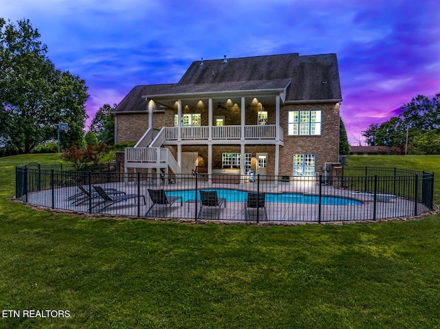 rear view of property with a patio area, stairway, brick siding, and a balcony