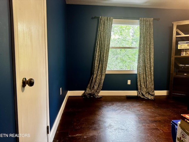 spare room featuring baseboards
