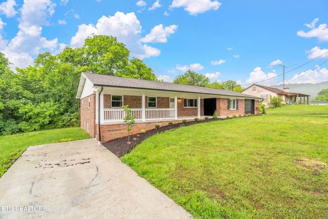 7220 Beelertown Rd, Powell, TN 37849 - ranch-style house featuring a porch, brick siding, and a front yard