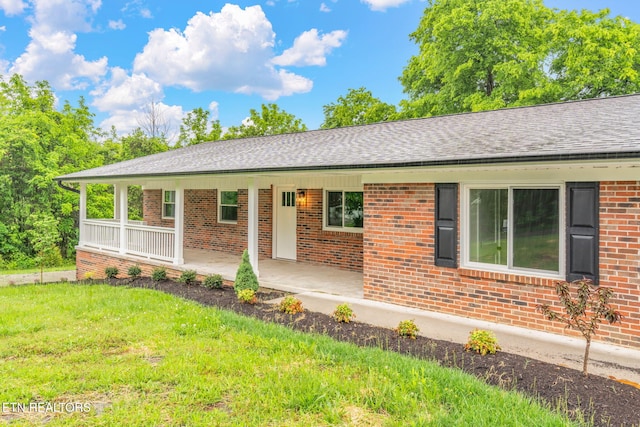 7220 Beelertown Rd, Powell, TN 37849 - single story home with brick siding, a front yard, covered porch, and a shingled roof