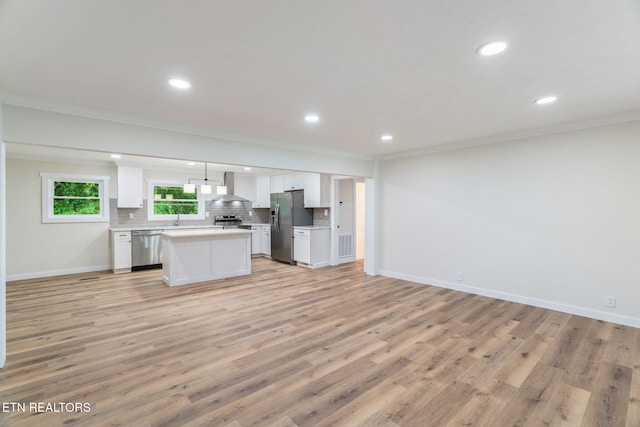 7220 Beelertown Rd, Powell, TN 37849 - kitchen featuring wall chimney exhaust hood, appliances with stainless steel finishes, ornamental molding, open floor plan, and white cabinets