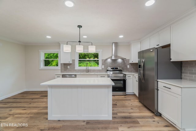 7220 Beelertown Rd, Powell, TN 37849 - kitchen featuring appliances with stainless steel finishes, wall chimney range hood, a sink, white cabinets, and ornamental molding