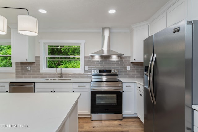 7220 Beelertown Rd, Powell, TN 37849 - kitchen with appliances with stainless steel finishes, a sink, wall chimney exhaust hood, light countertops, and crown molding