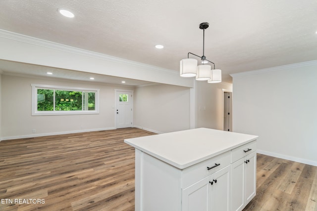 7220 Beelertown Rd, Powell, TN 37849 - kitchen featuring open floor plan, light wood finished floors, crown molding, a center island, and white cabinetry