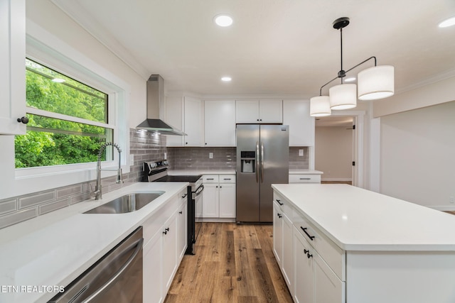 7220 Beelertown Rd, Powell, TN 37849 - kitchen featuring appliances with stainless steel finishes, wall chimney range hood, a sink, recessed lighting, and decorative backsplash