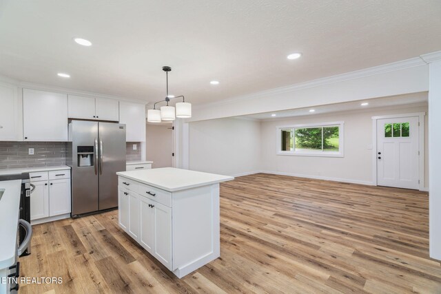 7220 Beelertown Rd, Powell, TN 37849 - kitchen with stainless steel fridge with ice dispenser, ornamental molding, decorative backsplash, white cabinets, and light countertops
