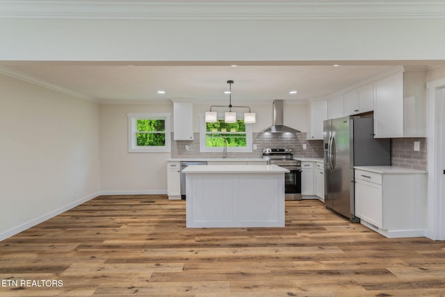 7220 Beelertown Rd, Powell, TN 37849 - kitchen with stainless steel appliances, wall chimney exhaust hood, crown molding, white cabinets, and tasteful backsplash
