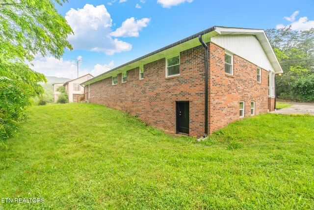 7220 Beelertown Rd, Powell, TN 37849 - view of side of home with a lawn and brick siding