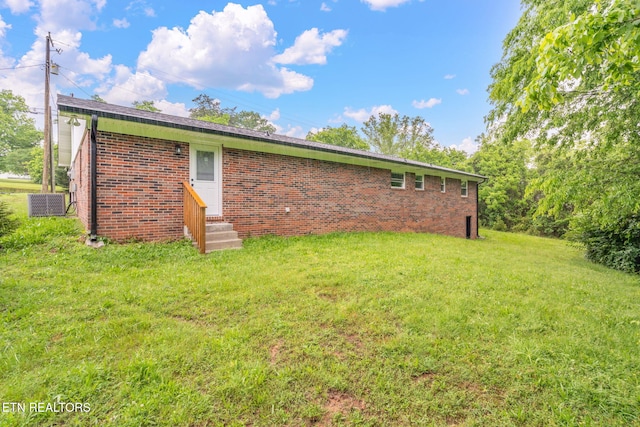 7220 Beelertown Rd, Powell, TN 37849 - back of house featuring entry steps, brick siding, a yard, and cooling unit
