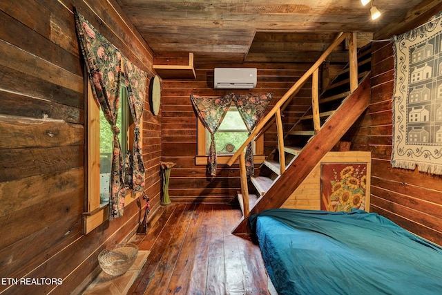 unfurnished bedroom with wooden walls, wooden ceiling, and hardwood / wood-style flooring