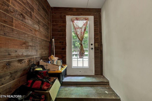 doorway featuring wood walls