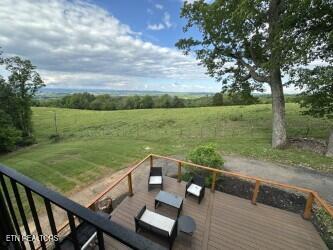 view of yard with a rural view and a deck