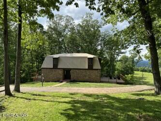 view of front of home with a front lawn and stone siding