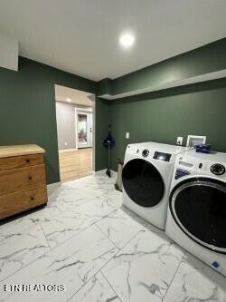 clothes washing area with recessed lighting, independent washer and dryer, marble finish floor, and laundry area