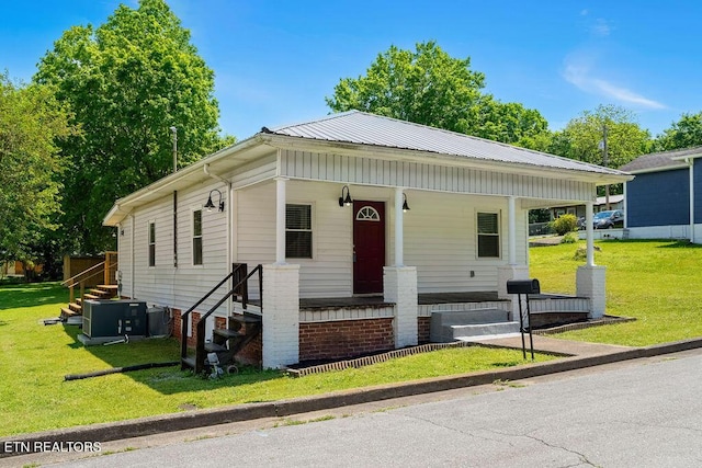 view of front of property with central AC unit, a front yard, and a porch