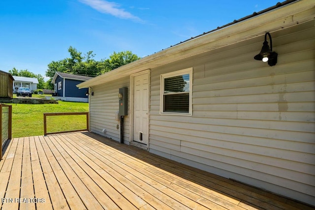 wooden deck featuring a yard