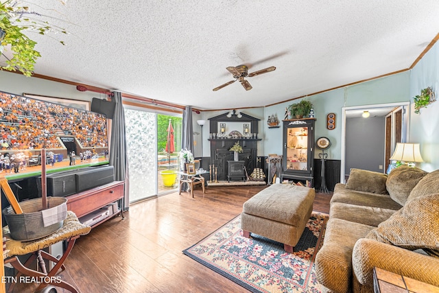 7726 Misty Point Way, Knoxville, TN 37914 - living area with crown molding, a wood stove, ceiling fan, a textured ceiling, and hardwood / wood-style flooring