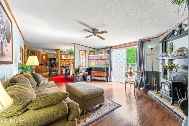 7726 Misty Point Way, Knoxville, TN 37914 - living area with ornamental molding, a wood stove, ceiling fan, a textured ceiling, and wood finished floors