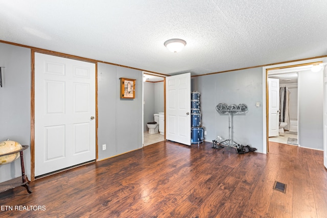 7726 Misty Point Way, Knoxville, TN 37914 - unfurnished bedroom featuring ornamental molding, wood finished floors, ensuite bath, and a textured ceiling