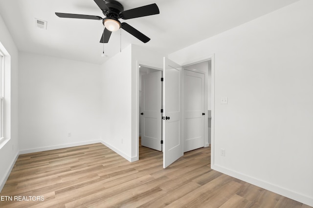 unfurnished bedroom featuring light wood-style floors, visible vents, baseboards, and ceiling fan