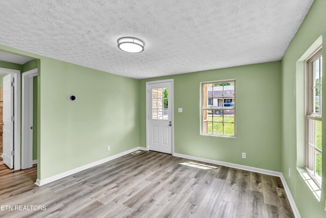 2423 Mccroskey Ave, Knoxville, TN 37917 - entrance foyer with wood finished floors, a textured ceiling, and baseboards