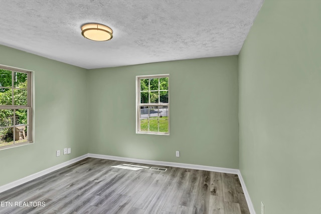 2423 Mccroskey Ave, Knoxville, TN 37917 - spare room with baseboards, wood finished floors, and a textured ceiling