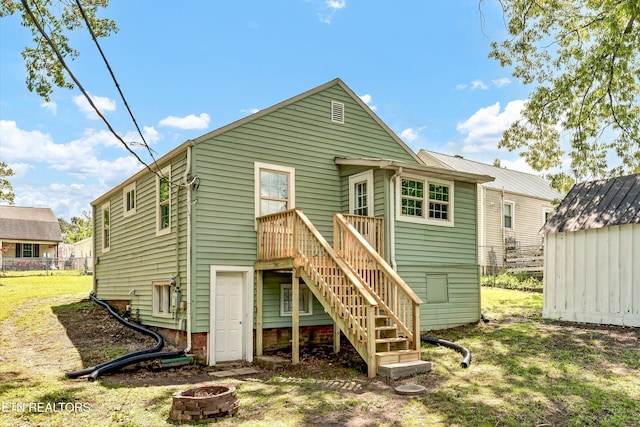 2423 Mccroskey Ave, Knoxville, TN 37917 - rear view of house with an outdoor fire pit, a shed, an outdoor structure, stairs, and fence
