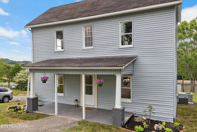 501 Ferry St, Loudon, TN 37774 - view of front facade featuring covered porch, cooling unit, and roof with shingles