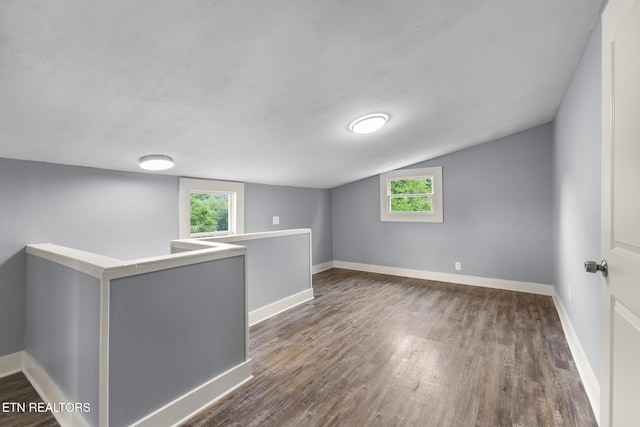 501 Ferry St, Loudon, TN 37774 - spare room with wood finished floors, plenty of natural light, vaulted ceiling, and baseboards