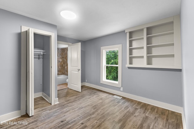501 Ferry St, Loudon, TN 37774 - unfurnished bedroom featuring wood finished floors, baseboards, and a closet