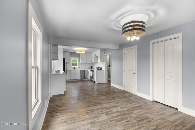 501 Ferry St, Loudon, TN 37774 - unfurnished living room with a chandelier, dark wood finished floors, and baseboards