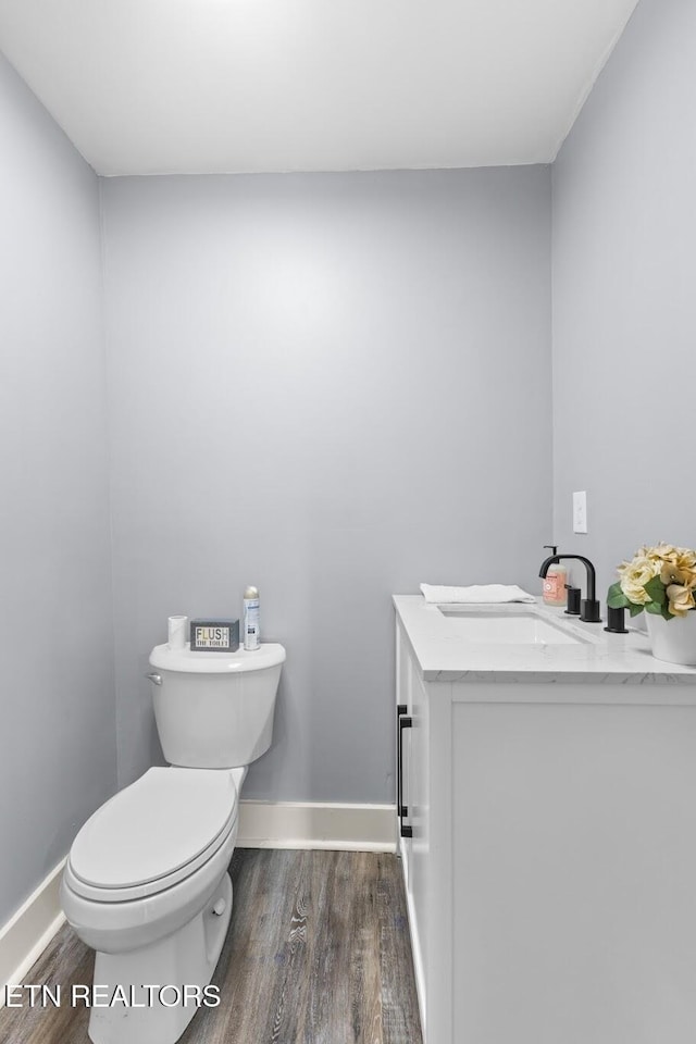 501 Ferry St, Loudon, TN 37774 - half bathroom with wood finished floors, toilet, vanity, and baseboards
