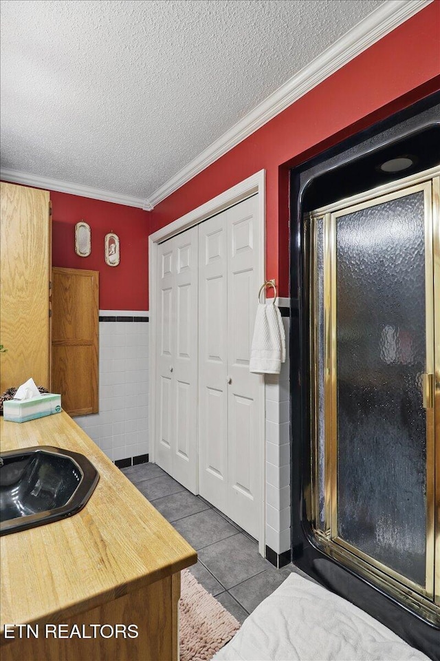 523 N 30th St, Middlesboro, KY 40965 - kitchen featuring a sink, wood counters, a textured ceiling, tile patterned flooring, and ornamental molding