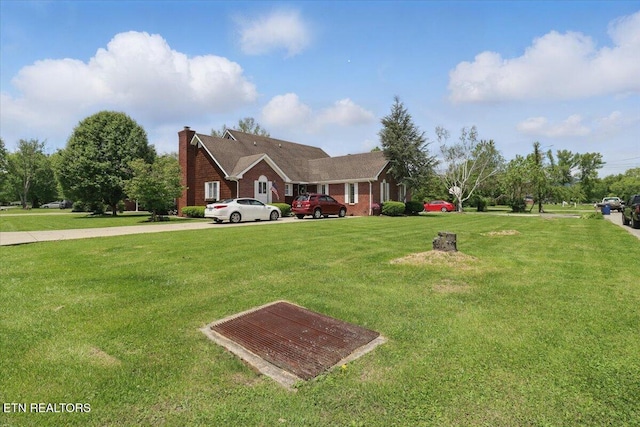523 N 30th St, Middlesboro, KY 40965 - view of front of house featuring a front lawn, a chimney, and brick siding