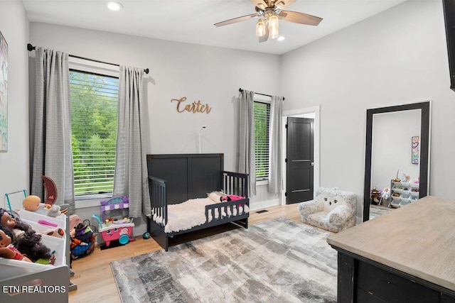 bedroom featuring multiple windows, recessed lighting, and wood finished floors