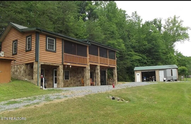 1026 Blue Mill Rd, Del Rio, TN 37727 - rear view of property featuring stone siding, a sunroom, a lawn, an outdoor structure, and driveway