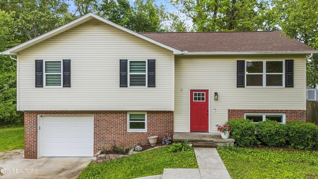 10212 Birch Hill Ln, Knoxville, TN 37932 - raised ranch featuring brick siding, an attached garage, and a front lawn