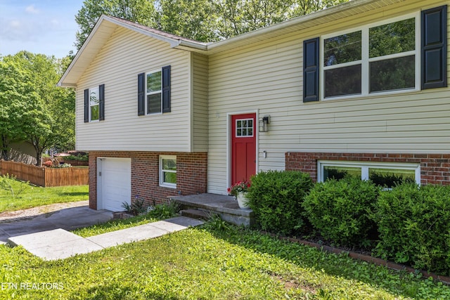 10212 Birch Hill Ln, Knoxville, TN 37932 - split foyer home with an attached garage, brick siding, and asphalt driveway