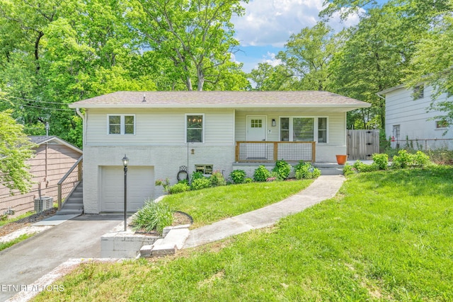 view of front of house featuring covered porch, an attached garage, brick siding, driveway, and a front lawn