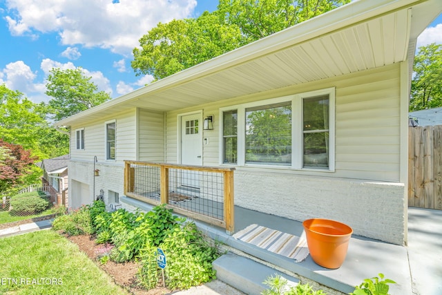 ranch-style home featuring fence