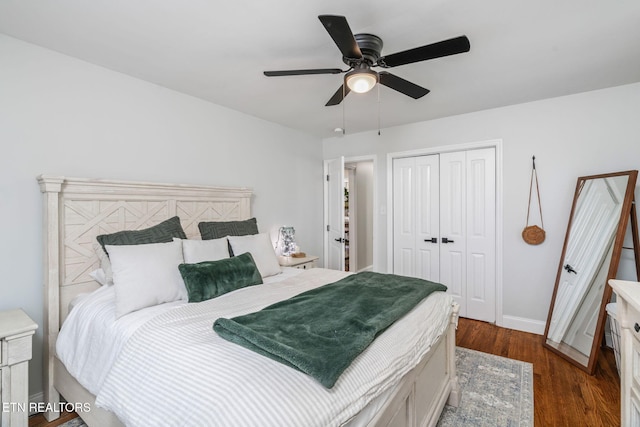 bedroom featuring a closet, dark wood-type flooring, baseboards, and ceiling fan