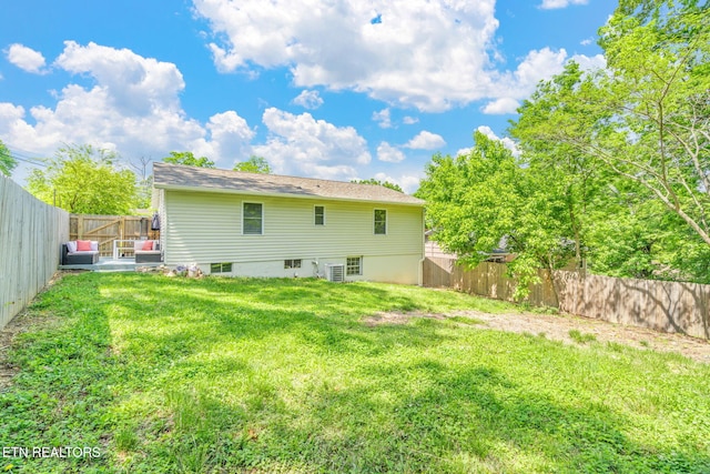 back of property featuring a fenced backyard and a lawn