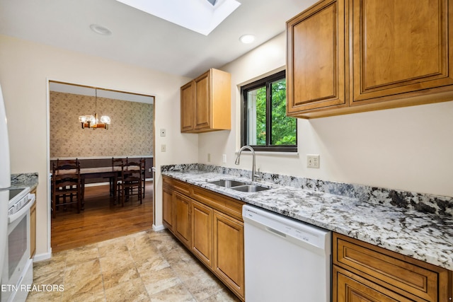 131 Clifton Cir, Oak Ridge, TN 37830 - kitchen featuring white appliances, a sink, brown cabinetry, a skylight, and light stone counters