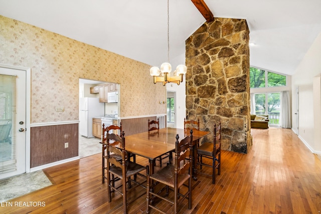 131 Clifton Cir, Oak Ridge, TN 37830 - dining space with wainscoting, light wood-style flooring, a chandelier, beamed ceiling, and high vaulted ceiling